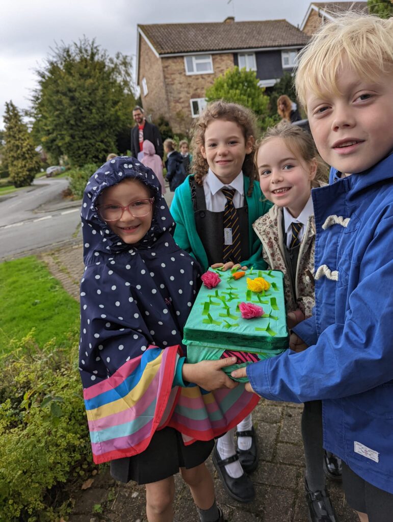 4 children holding a harvest box