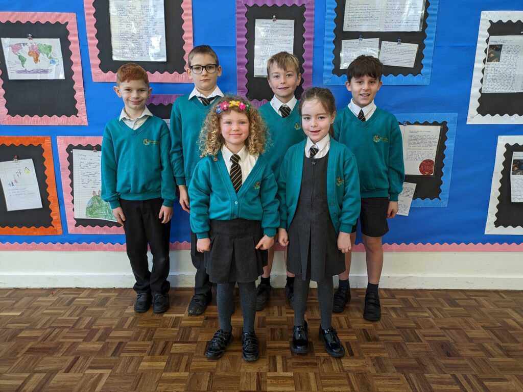 Photo showing winners of the Horsmonden Hero award holding up their certificates and smiling for the camera.